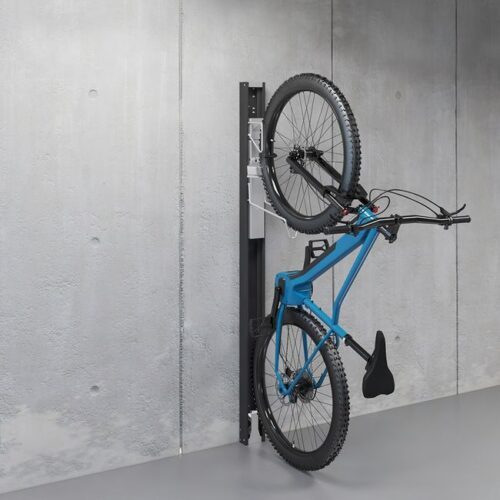 The innovative bike lift attached to a gray concrete wall with a mounted blue bike